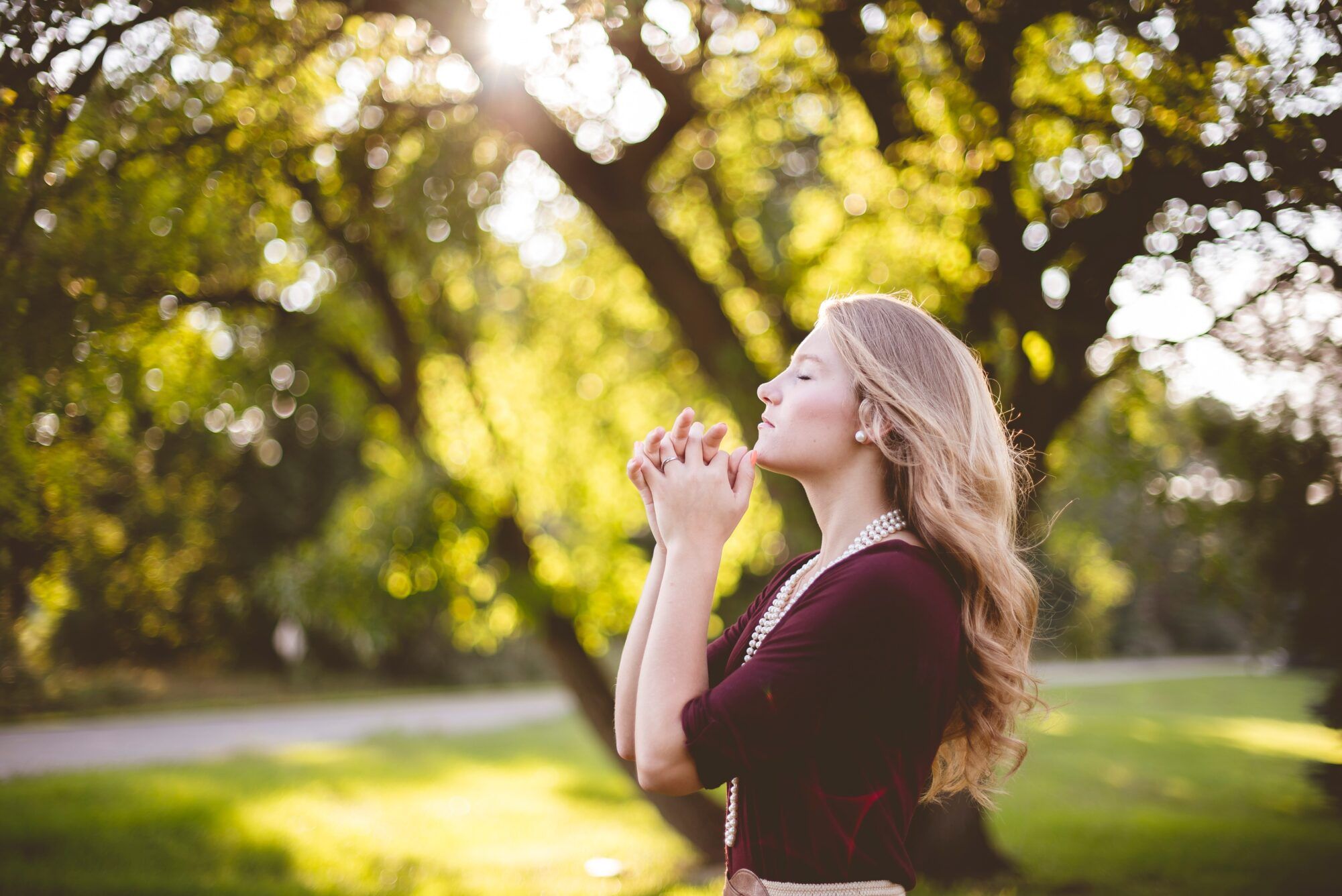 ben white praying lady unsplash scaled