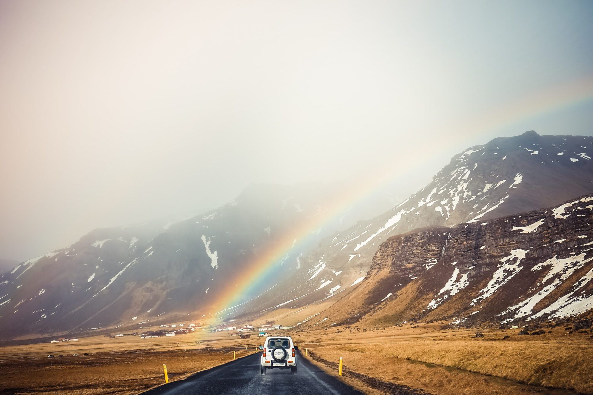 calvin chou Iceland rainbow car road unsplash scaled