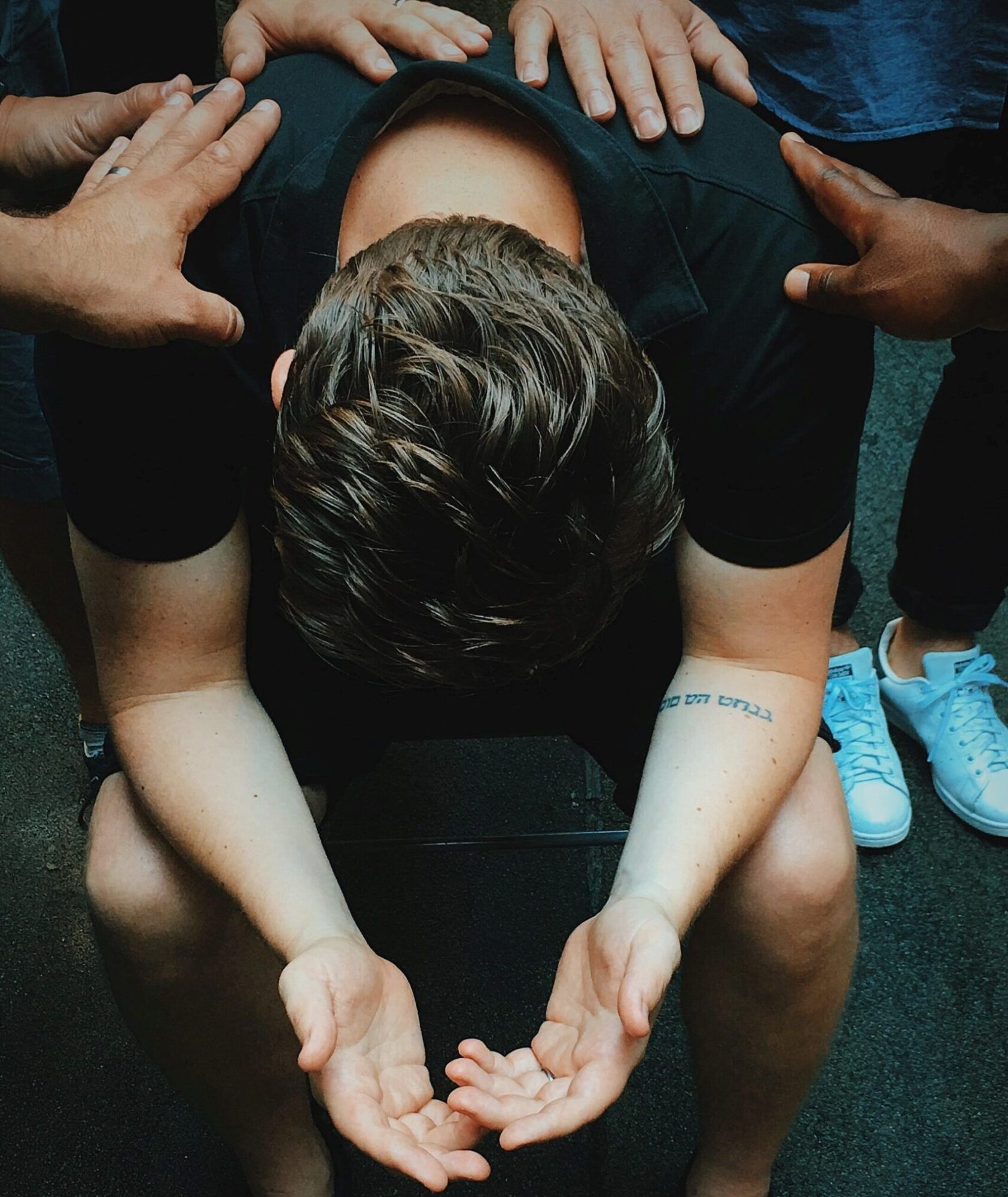 jon tyson praying over man unsplash scaled 1 scaled