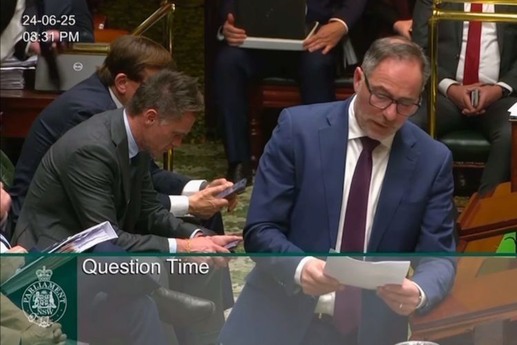 Premier Minns on Phone During Self Identity