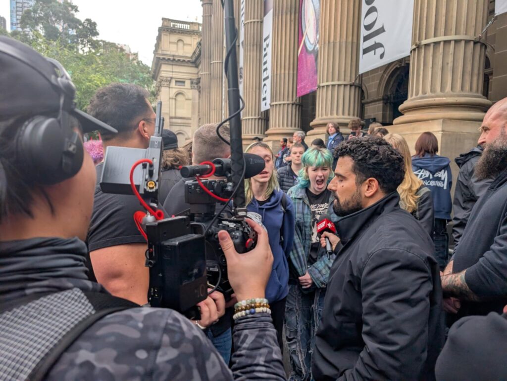 Rally attendees scream 'f..k off Nazis' at independent reporter, Avi Yemeni, and his cameramen. Picture: Josh Spasaro.