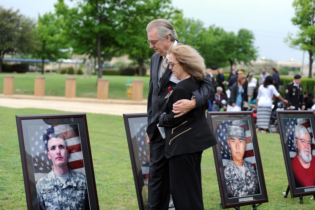 Jeffrey and Sheryll Pearson pause to look at the portrait of their son, Pfc. Michael Pearson, before the start of the Fort Hood Purple Heart and Defense of Freedom Medal Ceremony Friday, April 10, at III Corps Headquarters, Fort Hood, Texas. (U.S. Army photo by Daniel Cernero, III Corps and Fort Hood Public Affairs)